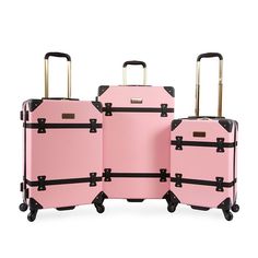 three pieces of pink luggage sitting next to each other with black handles and straps on wheels