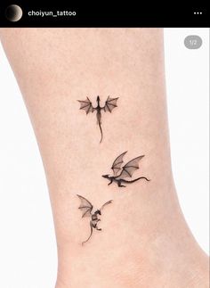 two small dragon tattoos on the ankle, one is black and one is grey with white outline