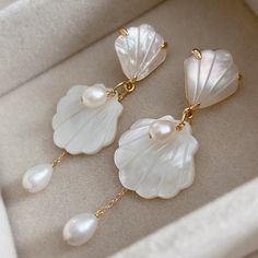 * DETAILS * - Carved Natural Sea Shell Charms 22*23mm - Gold Plated Natural White Shell Earrings Post (sterling silver pin) 15*18.5mm - Natural Freshwater Pearl  ✨More color available. Here is link. https://www.etsy.com/shop/JinnysJewelryBySeJin?load_webview=1&bid=DKdp4Kze9P_dkVpUpma7aznR4NlZ ----------------------------------------- * CARE TIPS * - Perfumes: Be sure any perfume or lotions are completely absorbed into skin. - Hair products: Apply all hair products before putting on jewelry. - Swimming: Remove all jewelry before swimming or getting into hot tubes. - No sunlight: Store away from heat, direct sunlight, window sills and vents. - Bedtime: Take off all jewelry before bed - No tissue: Never use tissue or paper towel to clean silver. - polish cloth: Use special jewelry polish clot Shell Pearl Earrings, White Shell-shaped Earrings For Jewelry Making, Beach Wedding Earrings, Earrings Summer, Bold Earrings, Bride Earrings, Skin Hair, Jewelry Statement, Silver Pin