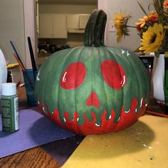 a painted pumpkin sitting on top of a table