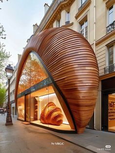 a large wooden object sitting on the side of a road next to a tall building