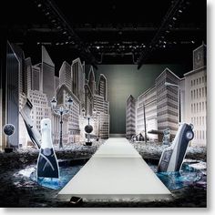 an image of a fashion show set up in the middle of a city with high rise buildings