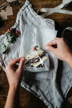 someone cutting up food on top of a white cloth next to some scissors and other items