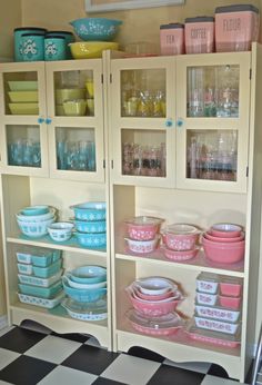 an old china cabinet filled with dishes and cups