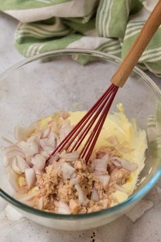 an image of food in a glass bowl with whisked onions and meat on the side