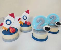 there are three cakes decorated to look like rockets on top of each other and the number twenty two