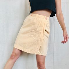 "Vintage Peach Wrap Mini Skirt Size Small Adorable skirt with two front Buttons and Double Pockets on Back Modeled on a Size Small 28\"Waist 38\"Hip 20\"Length 100% Cotton" Spring Mini Cargo Skirt With Elastic Waistband, Cotton Cargo Skirt With Elastic Waistband For Summer, Casual Knee-length Skort For Spring, Spring High Waist Lined Cargo Skirt, Spring High Waist Cargo Skirt, Short Length Relaxed Cargo Skirt For Spring, Spring Mini Length Relaxed Cargo Skirt, Spring Fitted Wrap Skirt With Pockets, Fitted Spring Wrap Skirt With Pockets