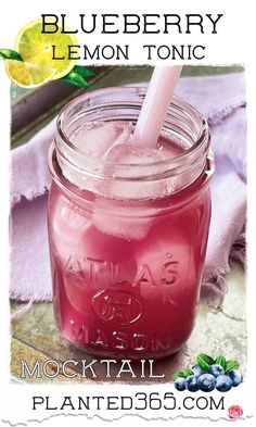 a blueberry lemon tonic is in a mason jar with a straw and garnish