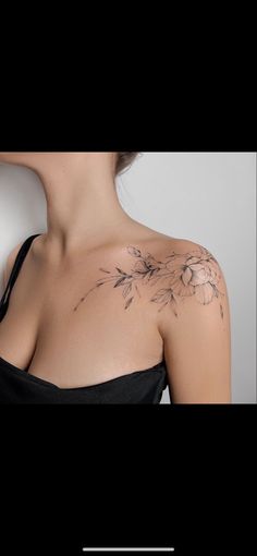 a woman's shoulder with flowers on it, and the back of her neck