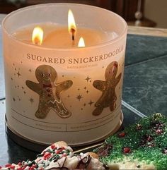 a candle that is sitting next to some cookies