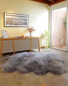 a living room with a large rug on the floor