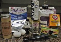 an assortment of ingredients are sitting on the counter top, including eggs, flour, butter, and other items