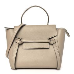 This is an authentic CELINE Grained Calfskin Nano Belt Bag in Light Taupe. This tote is crafted of textured calfskin leather in light taupe with gold hardware. The bag features a leather strap top handle, an optional adjustable strap, and a facing flap secured by a strap and magnetic clasp. The top flap and gold zipper opens to a beige suede leather interior. Bag Light, Strap Top, Strap Tops, Gold Zipper, Magnetic Clasp, Leather Interior, Leather Top, Belt Bag, Suede Leather