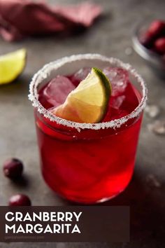 the cranberry margarita is garnished with a lime and sugar on top