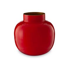 a red vase is sitting on a white surface