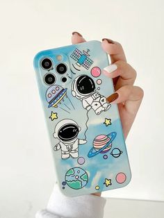 a person holding up a phone case with an image of an astronaut on it