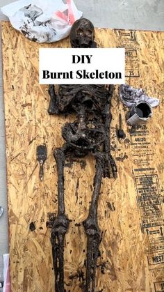 the skeleton is laying on top of plywood and has words over it that read diy burnt skeleton