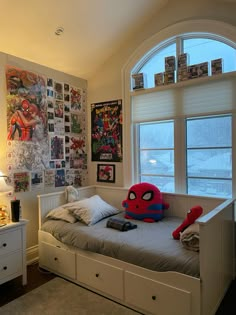 a bedroom with a spiderman pillow on the bed