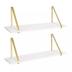 two white shelves with gold metal brackets