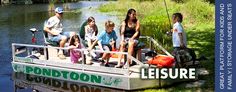 a group of people sitting on top of a boat in the middle of a river