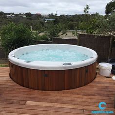 a hot tub sitting on top of a wooden deck