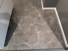 a bathroom floor with hexagonal tiles on it