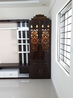 an empty room with white walls and black cabinets