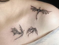 a woman's chest with three bats on it