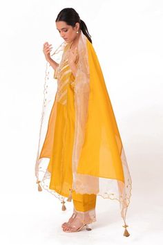 Golden yellow kurta with embroidered banarasi jacquard tissue yoke. Paired with a slub silk pant and chanderi dupatta with scalloped tissue detailing. - Aza Fashions Tissue Silk Traditional Drape Sets, Yellow Anarkali Set With Sheer Dupatta, Tissue Silk Dupatta With Dabka, Unstitched Dabka Saree, Cotton Silk Palazzo Set For Navratri, Tissue Silk Dupatta For Navratri, Tissue Silk Salwar Kameez With Pallu, Yellow Salwar Kameez With Sheer Dupatta, Bollywood Style Dabka Saree