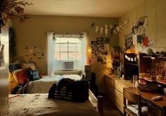 a dorm room with two beds, a dresser and a window in the corner that is open