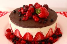 a chocolate cake topped with strawberries and berries