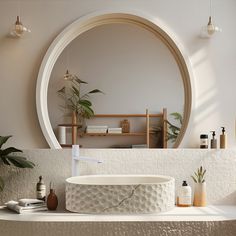 a circular mirror hangs above a sink in a bathroom with plants and other items on the counter