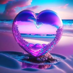 a heart shaped object sitting on top of a sandy beach