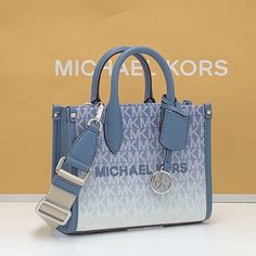 Michael Kors Mirella Extra-Small Ombr Logo Crossbody Xbody Shopper Bag Denim Nwt Authentic Whether You’re Heading To A Daytime Event Or Simply Running Errands, The Mirella Will Meet The Moment. Fit All Your Essentials Into This Charming Mini Tote, Which Can Be Carried By The Top Handles Or Worn Cross-Body Thanks To A Removable Strap. Printed With Our Initials In An Ombr Finish, It’s A Reliable Way To Spice Up Any Outfit. Crossbody Bag Logo-Print Canvas 90% Coated Canvas/10% Polyester Trim 1: 60% Coach Men’s Cross Body Bag, Michael Kors Shopper Bag, Cross Body Purse Michael Kors, Blue Top Handle Shoulder Bag With Logo, Blue Top Handle Bag With Logo, Silver Bags With Logo For Everyday Use, Blue Crossbody Shoulder Bag With Logo, Blue Logo Crossbody Shoulder Bag, Blue Logo Crossbody Bag