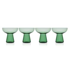 four green glass bowls lined up in a row