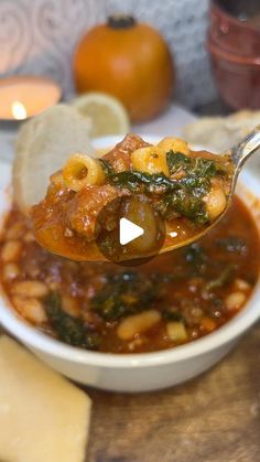 a spoon full of soup on top of a table