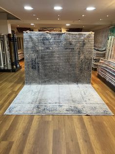 a carpet store with wooden floors and rugs on the floor