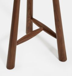 a wooden stool that has two legs on it