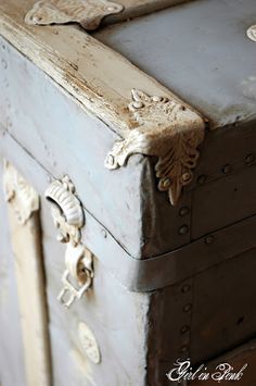 an old wooden chest with ornate carvings on the front and sides, painted in white