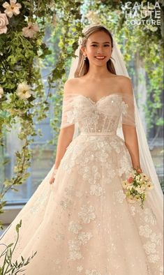 a woman in a wedding dress with flowers on it