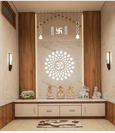 a white and brown room with buddha statues on the wall, chandelier and lights