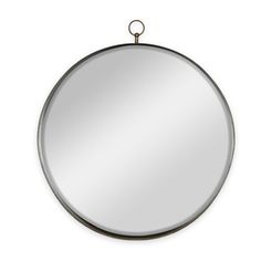 a round mirror hanging on the wall with a metal ring around it's edge