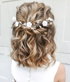 a woman with wavy hair and flowers in her hair