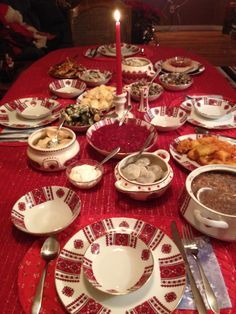 an image of a table with food on it and a candle in the middle that is lit