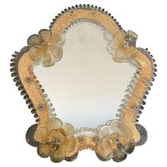 a decorative mirror with flowers on it