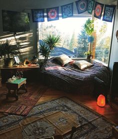 a bed room with a neatly made bed and lots of rugs on the floor