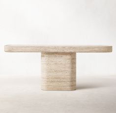 a white table sitting on top of a cement floor