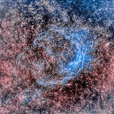 an image of a blue and red object in the middle of some space with stars all around it