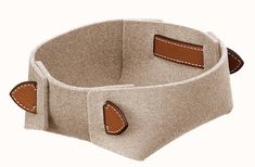 a beige belt with two brown leather buckles