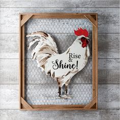 a wooden frame with a rooster on it and the words rise and shine painted on it